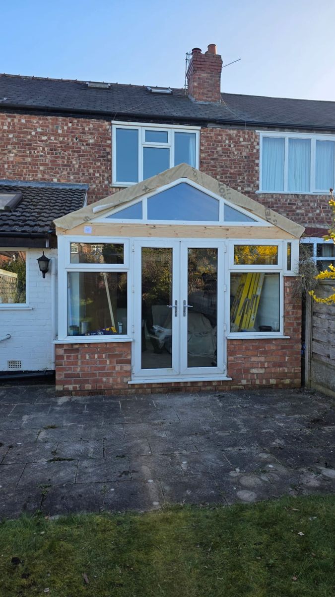 Conservatory with old glazed roof frame exposed, ready for tiled roof replacement