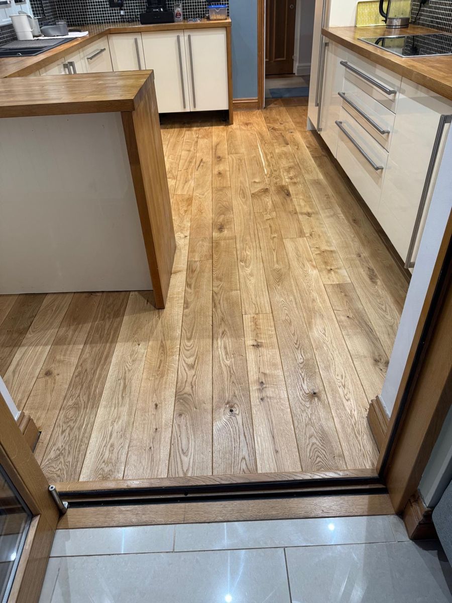 Finished solid oak flooring, sanded and stained, in kitchen